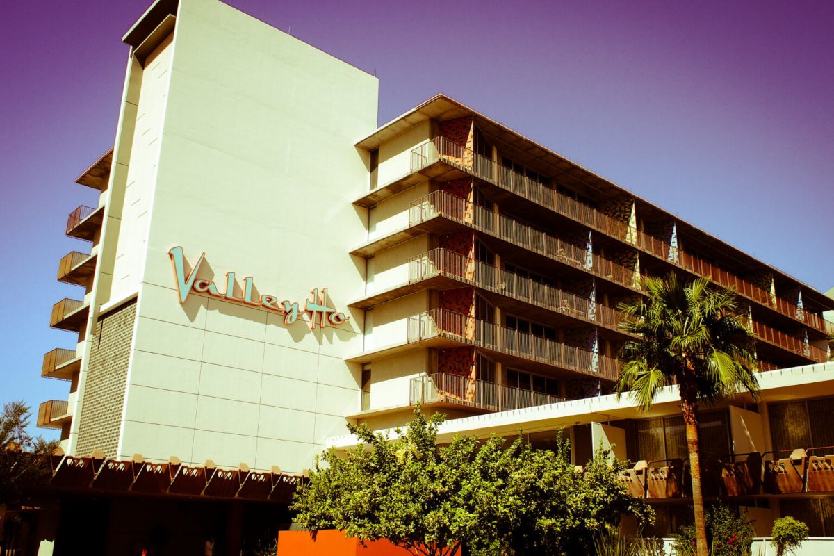 Mid-century modern Hotel Valley Ho with signature sign, palm trees, and purple sky—an icon of Scottsdale architecture.