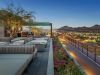 Modern rooftop terrace lounge at Optima Kierland with fire pits, vibrant flowers, and breathtaking views—perfect for walkable urban living.