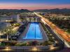 Rooftop pool at 7190-03 Residences lit at dusk, with city lights, lounge chairs, mountains, and Optima Kierland views.