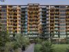 Modern apartment building with many balconies decorated with hanging plants, surrounded by greenery.