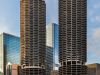 Two cylindrical high-rise towers with rounded balconies rise amid modern glass buildings, defining Chicago’s low-carbon cityscape.