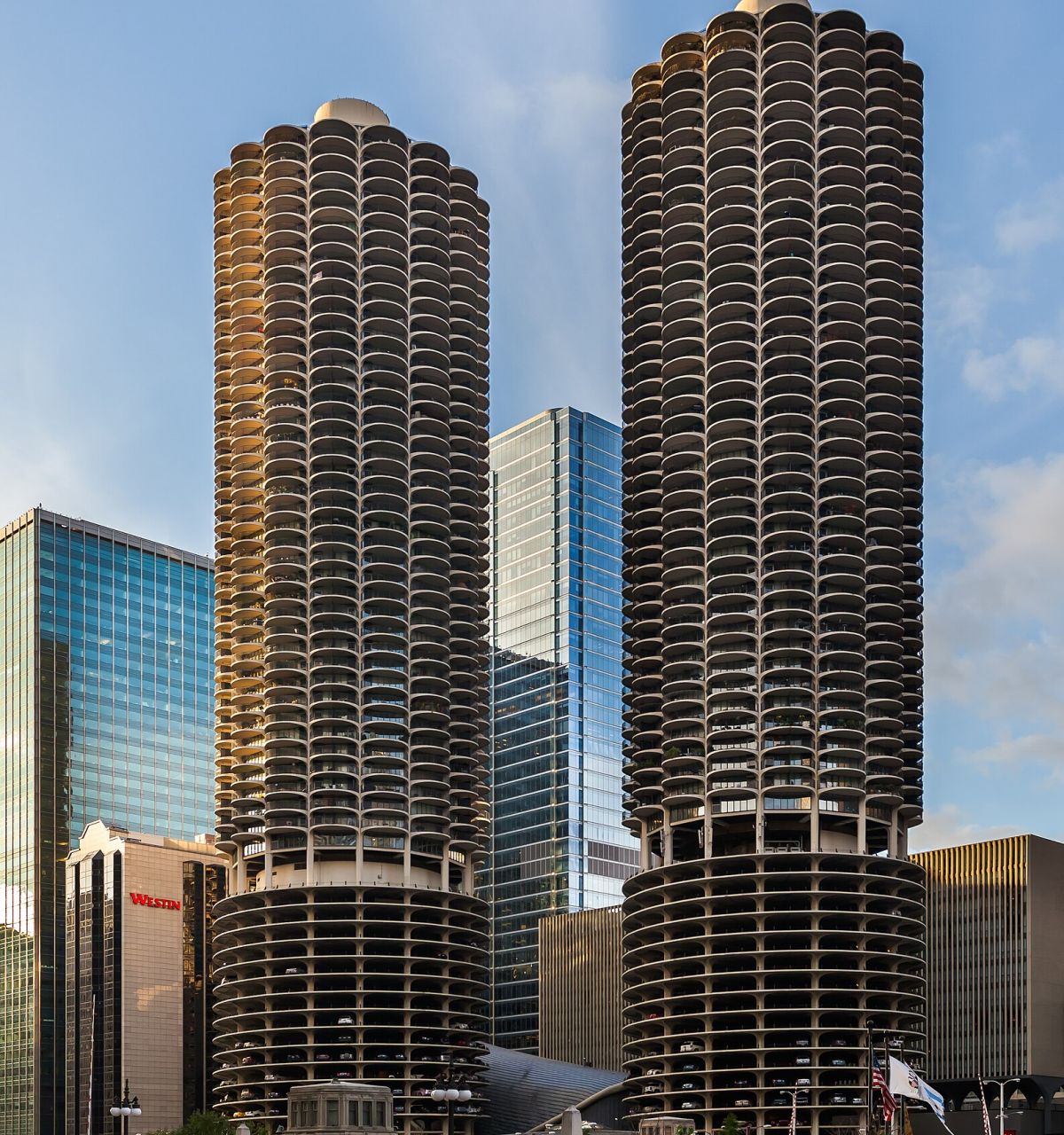 Two cylindrical high-rise towers with rounded balconies rise amid modern glass buildings, defining Chicago’s low-carbon cityscape.