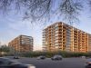 Two modern glass apartment buildings from the Optima Portfolio at sunset, with cars driving below and trees framing this vibrant living scene.