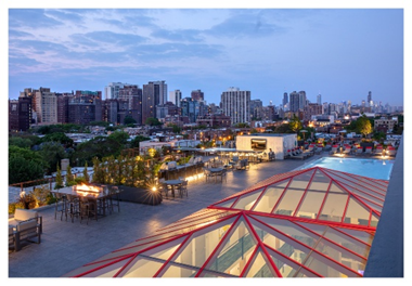 Rooftop with pool, seating areas, and city views at dusk—discover the elevated experience of Optima Sky Decks.